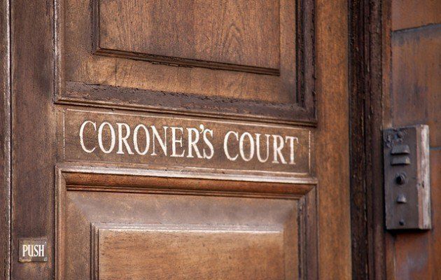 A wooden door with a sign that reads "CORONER'S COURT" 