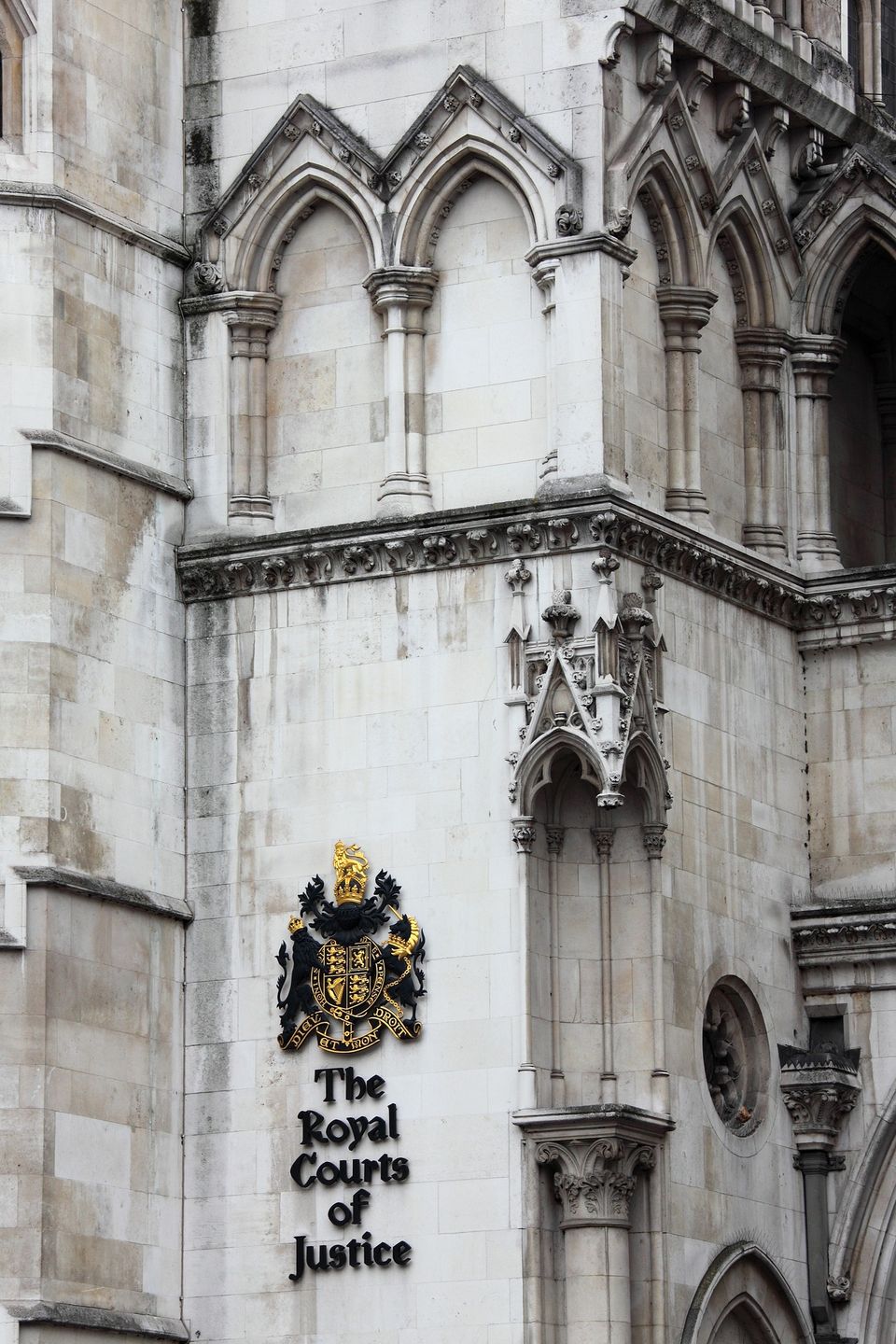 Ornate, Gothic-style building with the crest and sign for "The Royal Courts of Justice."